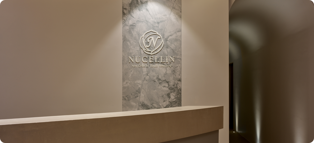 Marble logo wall behind the reception counter at Nucellin Orthopedic Clinic in Seoul